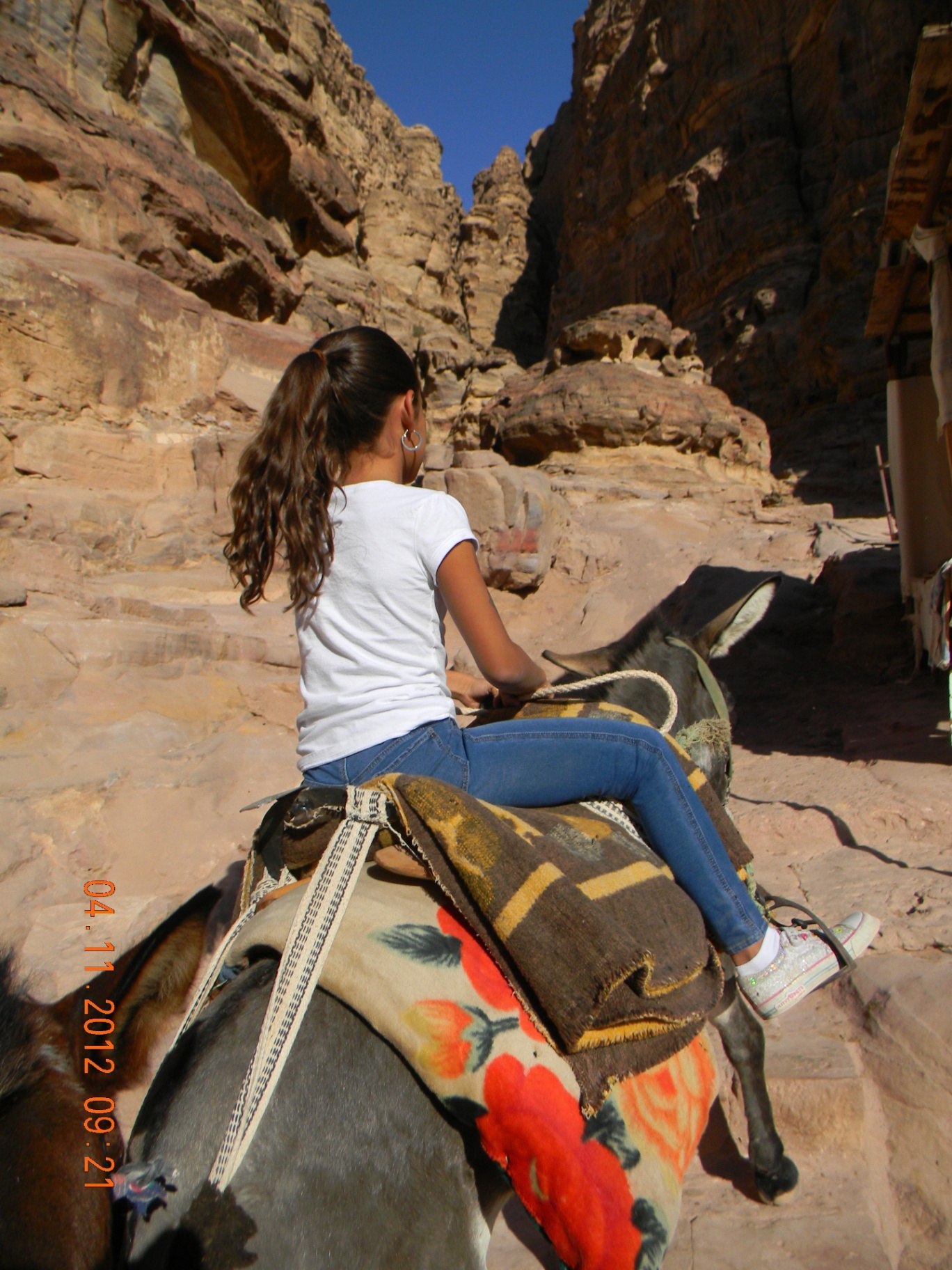 Riding a donkey up the rocks of Petra