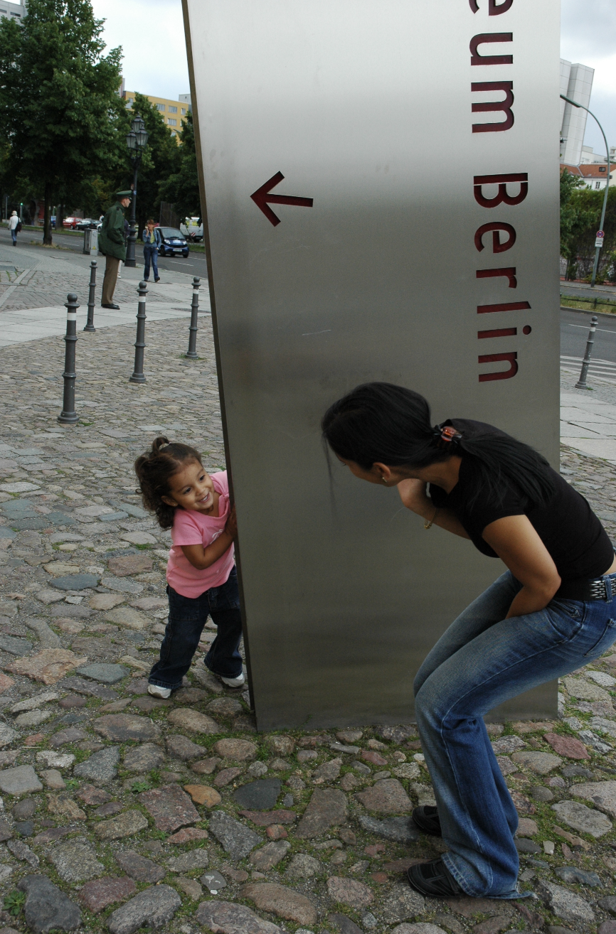 Childhood moment by a museum sign in Berlin